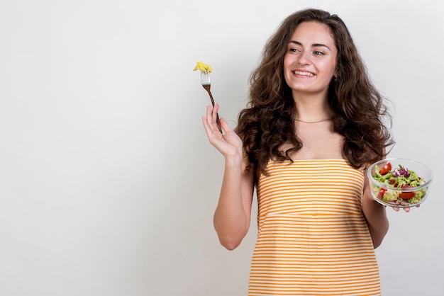 Woman eating a lettuce salad