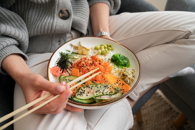 Free photo woman eating seafood dish with salmon