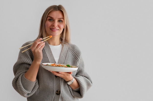 Free Photo woman eating seafood dish with salmon