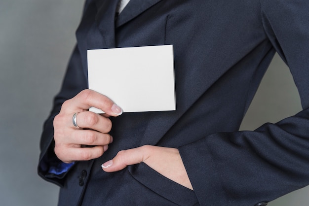 Free photo woman in elegant jacket holding blank paper