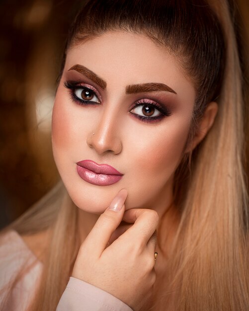 Woman in elegant suntanned makeup with blonde hair