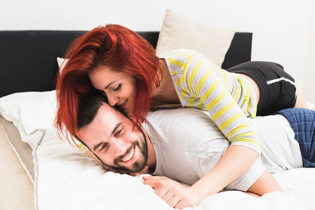 Woman embracing her husband on bed