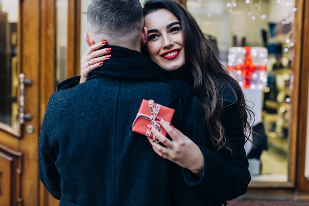 Free photo woman embracing man happy with present