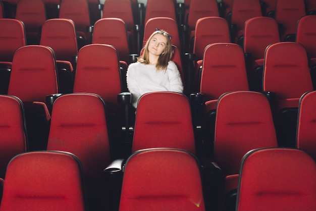 Free photo woman in empty cinema auditorium