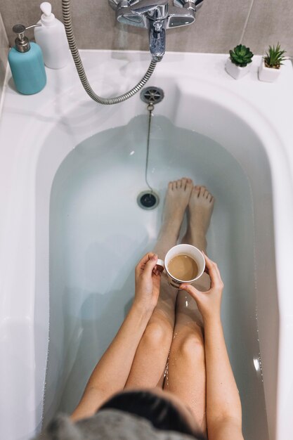 Woman enjoying coffee in bath