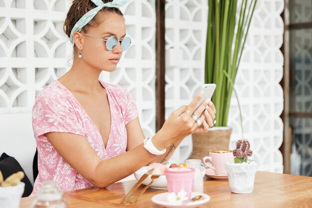 Woman enjoying dessert and drink in cafe