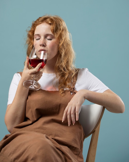 Free photo woman enjoying a glass of red wine