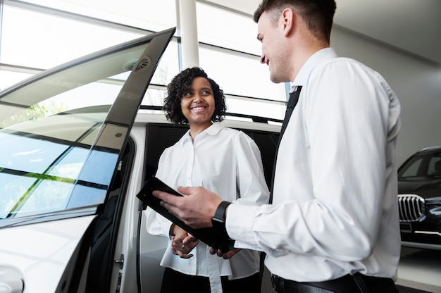 Woman enjoying her financially independence while buying car