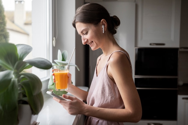 Free photo woman enjoying her juice recipe