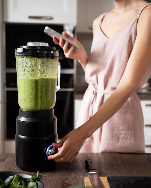 Free photo woman enjoying her juice recipe