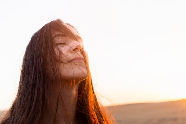 Woman enjoying her time in nature with sunset