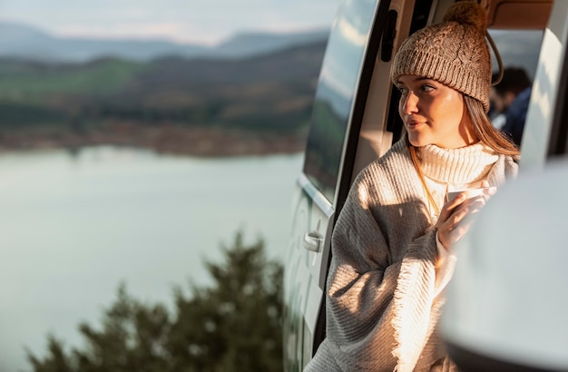 Woman enjoying the nature view from the car while on a road trip