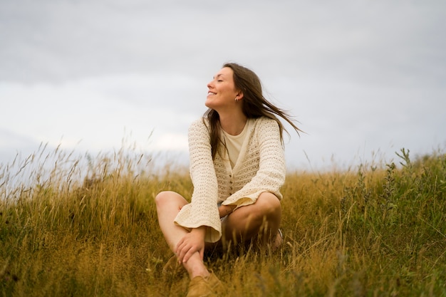 Woman enjoying nostalgic sunset at country side