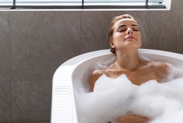 Woman enjoying a relaxing bubble bath