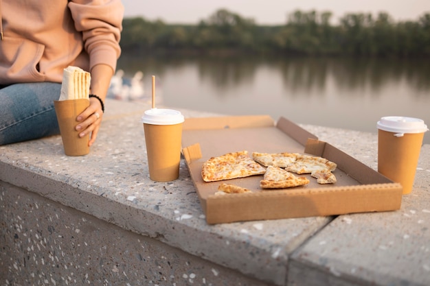 Free Photo woman enjoying some street food outdoors