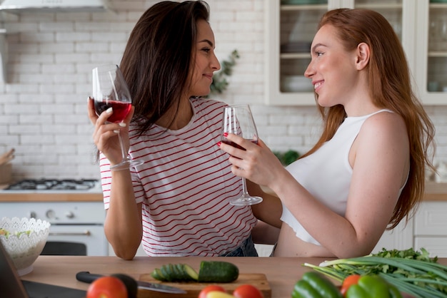 Woman enjoying some wine while cooking