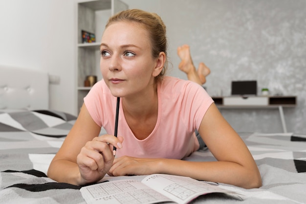 Free photo woman enjoying a sudoku game alone