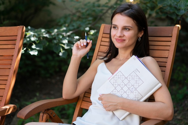 Woman enjoying a sudoku game on paper by herself