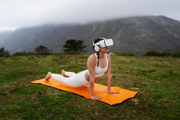 Woman exercising outdoors in nature with vr glasses