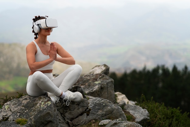 Free Photo woman exercising outdoors in nature with vr glasses