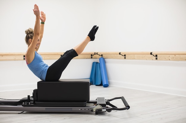 Woman exercising on reformer