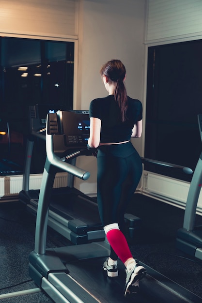 Free Photo woman exercising on treadmill in gym