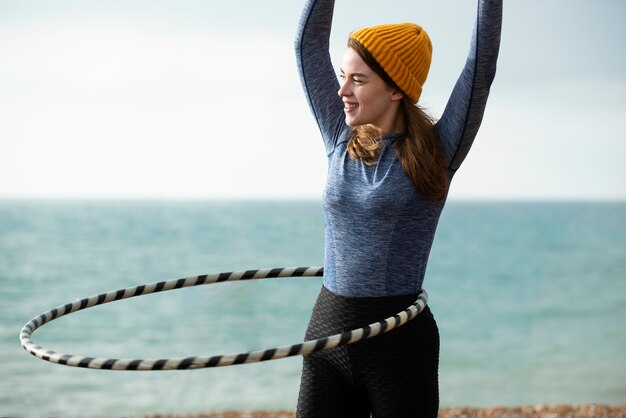 Woman exercising with hula hoop circle