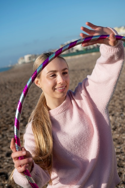 Free photo woman exercising with hula hoop circle