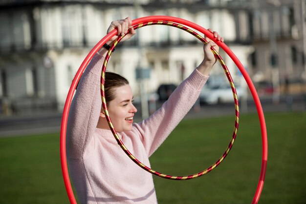 Woman exercising with hula hoop circle