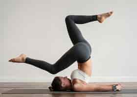 Free photo woman exercising yoga positions on mat