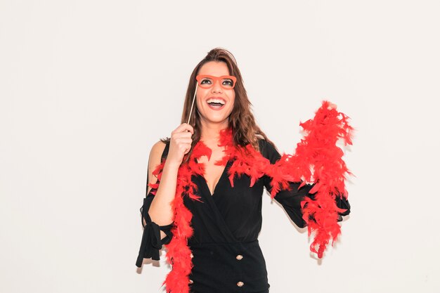 Woman in feather boa with paper glasses