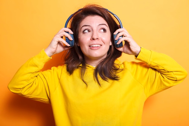 Free Photo woman feeling excited with headphones