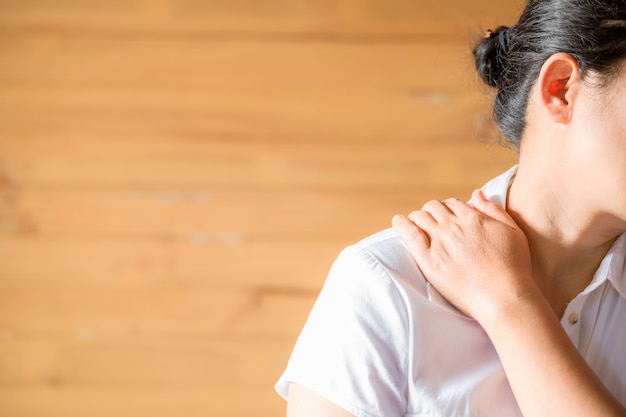 Free photo woman feeling exhausted and suffering from neck pain.