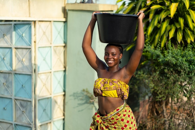 Free photo woman fetching water from outdoors