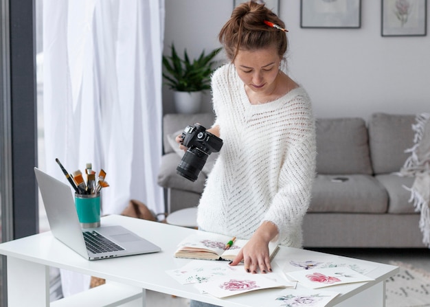 Woman filming her artwork