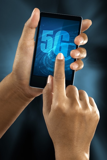 Free photo a woman finger connect to 5g network on a smart phone