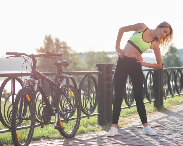 Woman in fitness clothes doing warm-up exercises