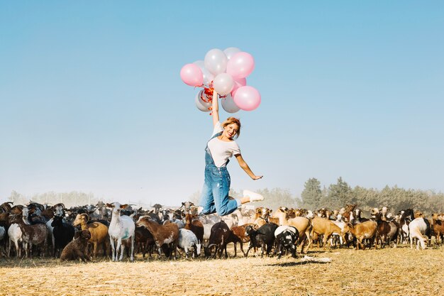 Woman flying on balloons