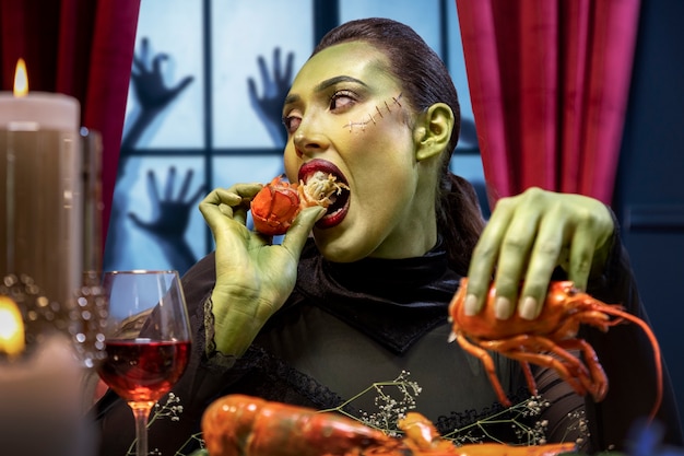 Free photo woman frankenstein eating medium shot