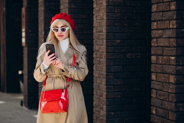 Woman in french beret using phone