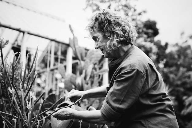 Woman gardening in a greenhouse