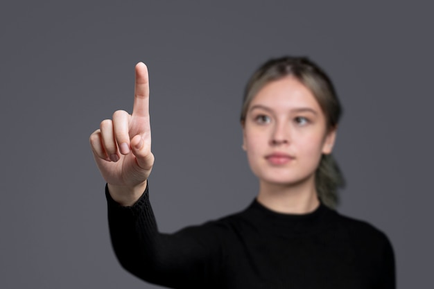 Woman gesture pressing on an invisible screen