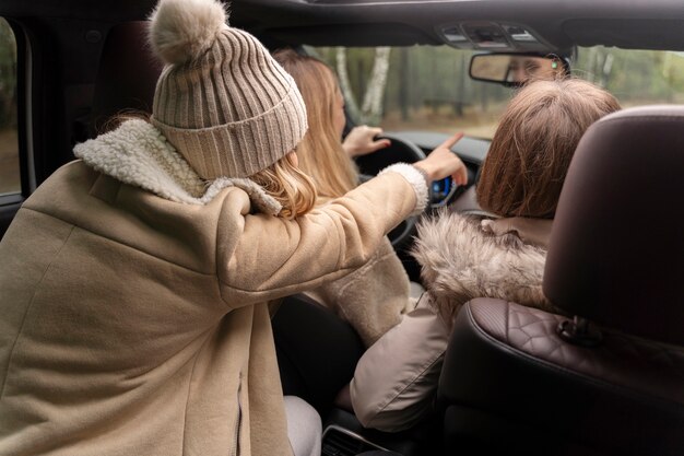 Woman getting directions from her friend while driving the car