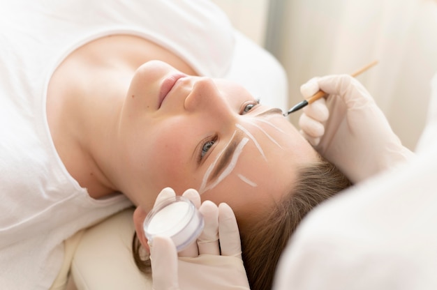 Woman getting an eyebrow treatment