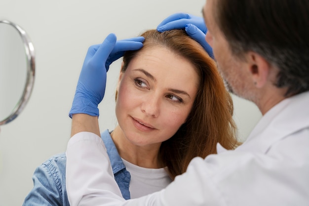 Free photo woman getting a hair loss treatment at a clinic