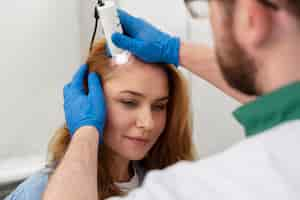 Free photo woman getting a hair loss treatment at a clinic