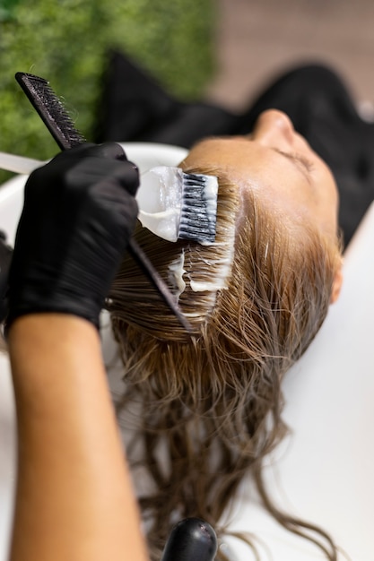 Free Photo woman getting her hair washed at the beauty salon