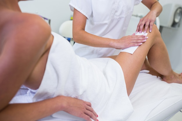 Woman getting her leg hair removed