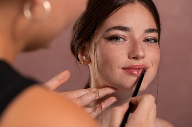 Free Photo woman getting her make up done by a professional