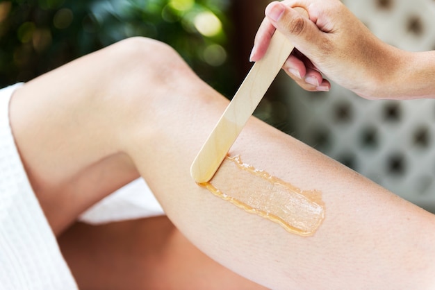 Woman getting legs waxed at a spa